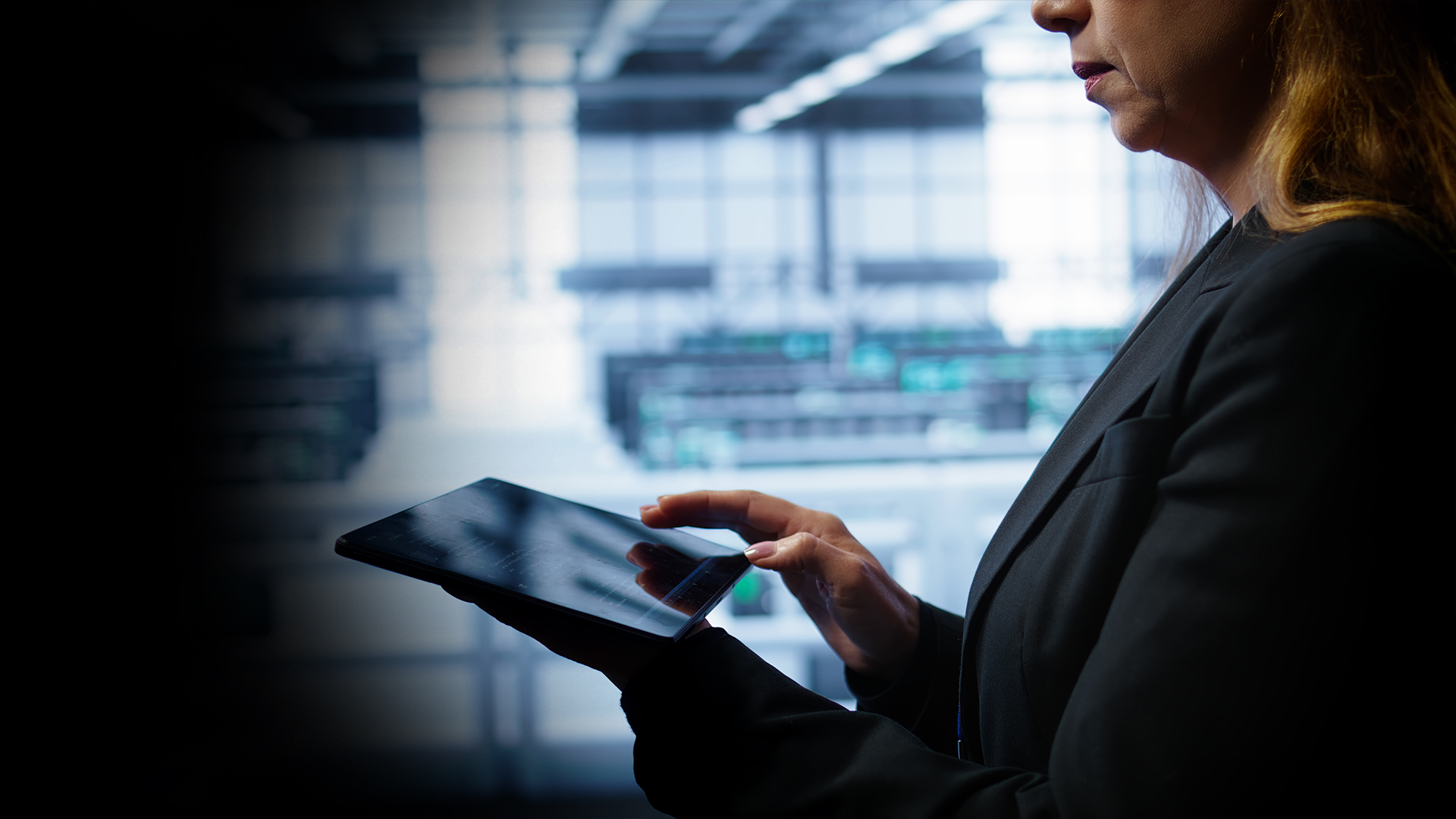 Business professional using a tablet during a cross-tenant Azure SQL migration and real-time data synchronization project.