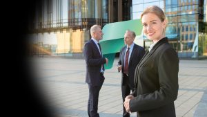 Business leaders collaborating with Microsoft Fabric to unify enterprise data, analytics, AI, and business intelligence for smarter decisions.