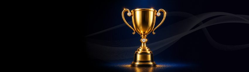 Gold trophy on a dark blue stage with shimmering reflections and tiny sparks at the base in a victory scene.
