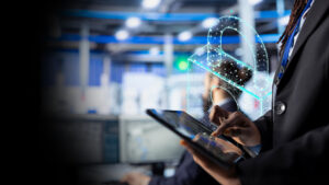 Professional using a tablet, with a glowing holographic padlock signifying cybersecurity.